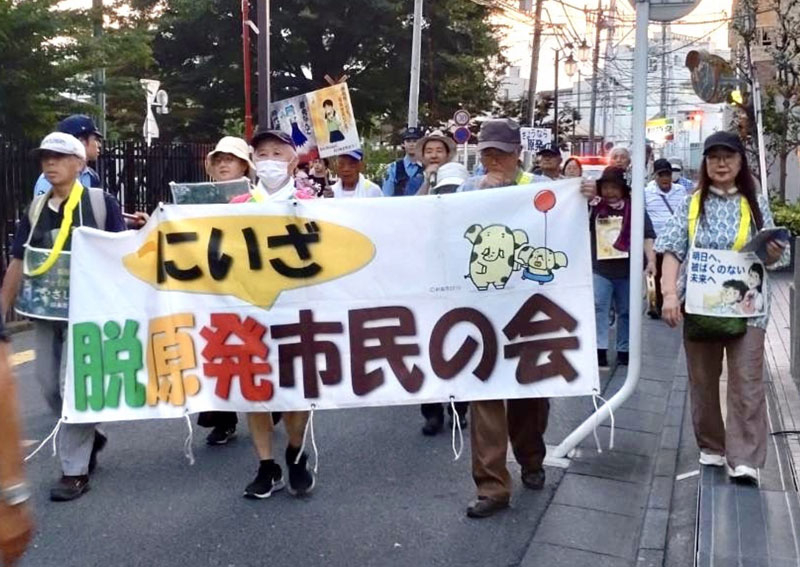 三軒屋公園前を歩くデモ隊